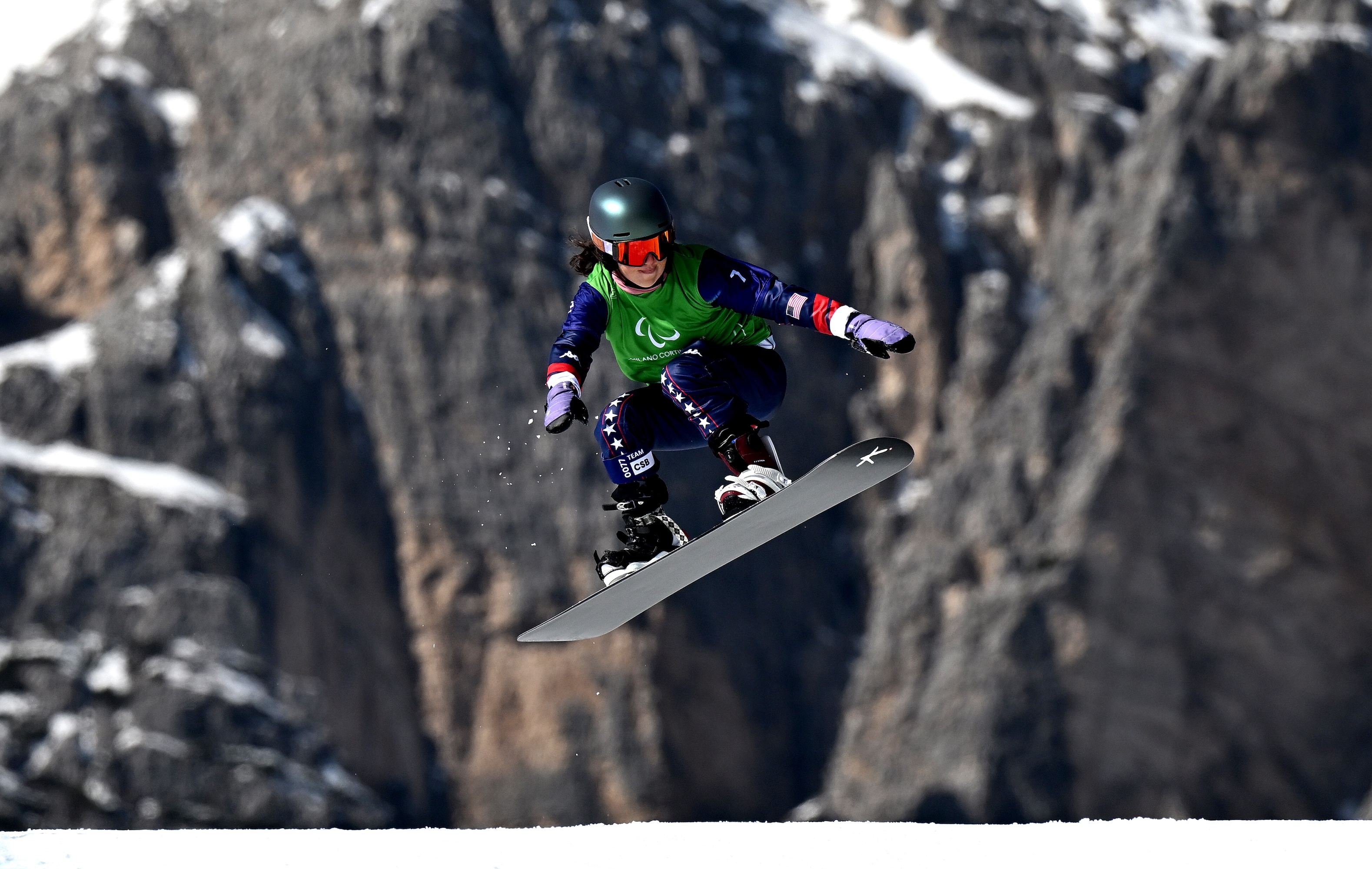 Kate Delson snowboards at the Paralympics