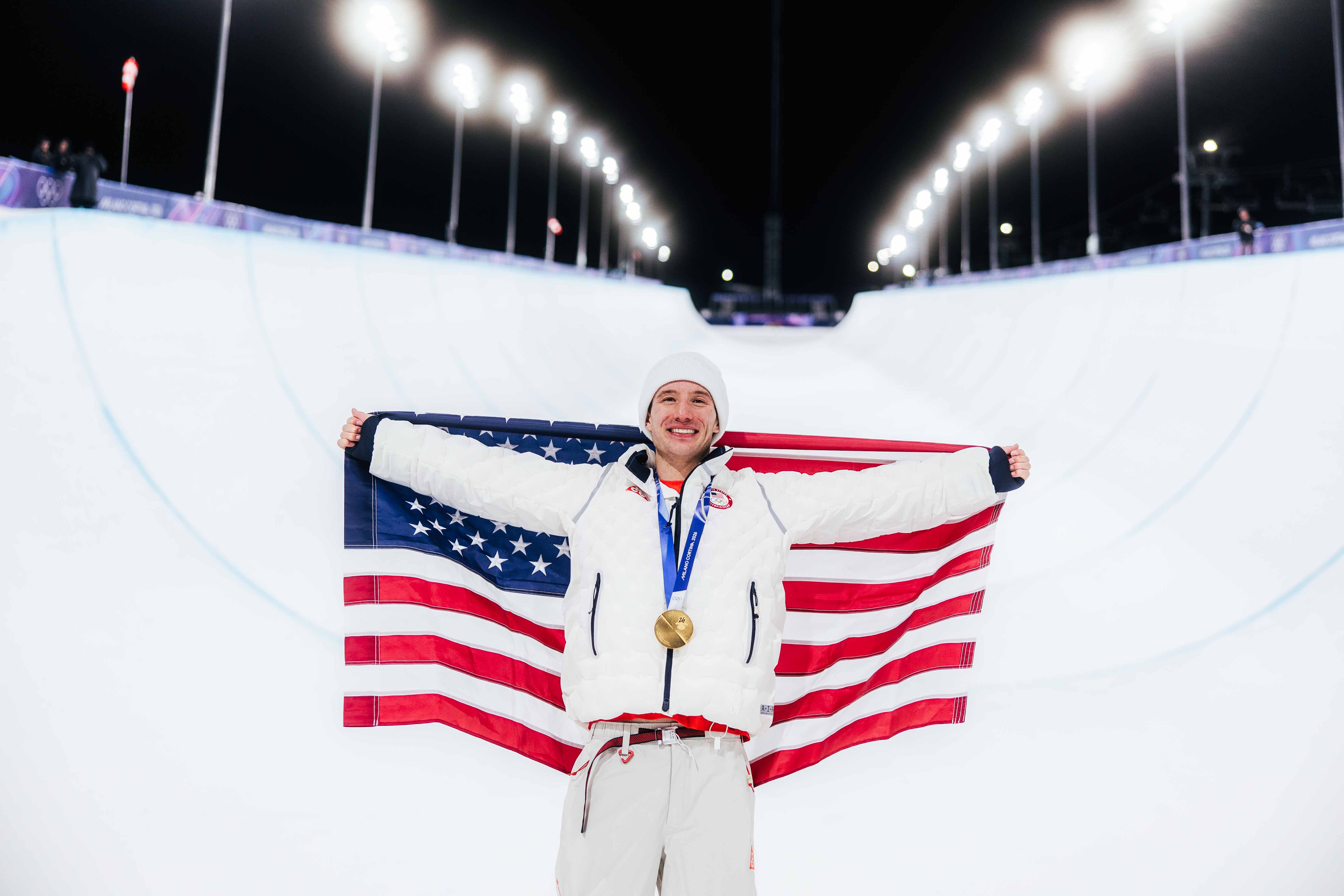 alex ferreira holding up an american flag