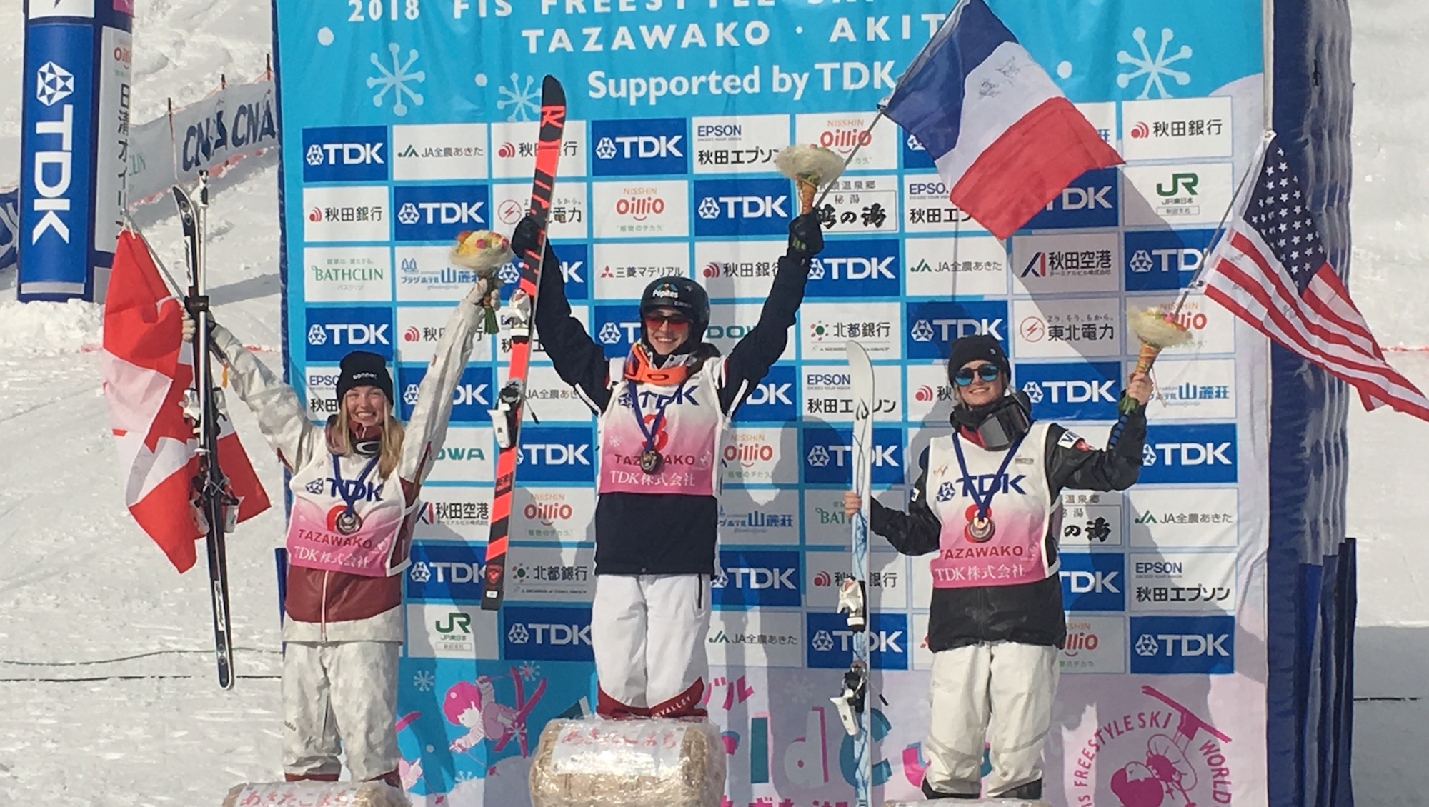 Keaton McCargo (right) celebrates her second career World Cup podium, a third place finish, with winner Perinne Laffont of France and second-place Justine Dufour-LaPointe of Canada.