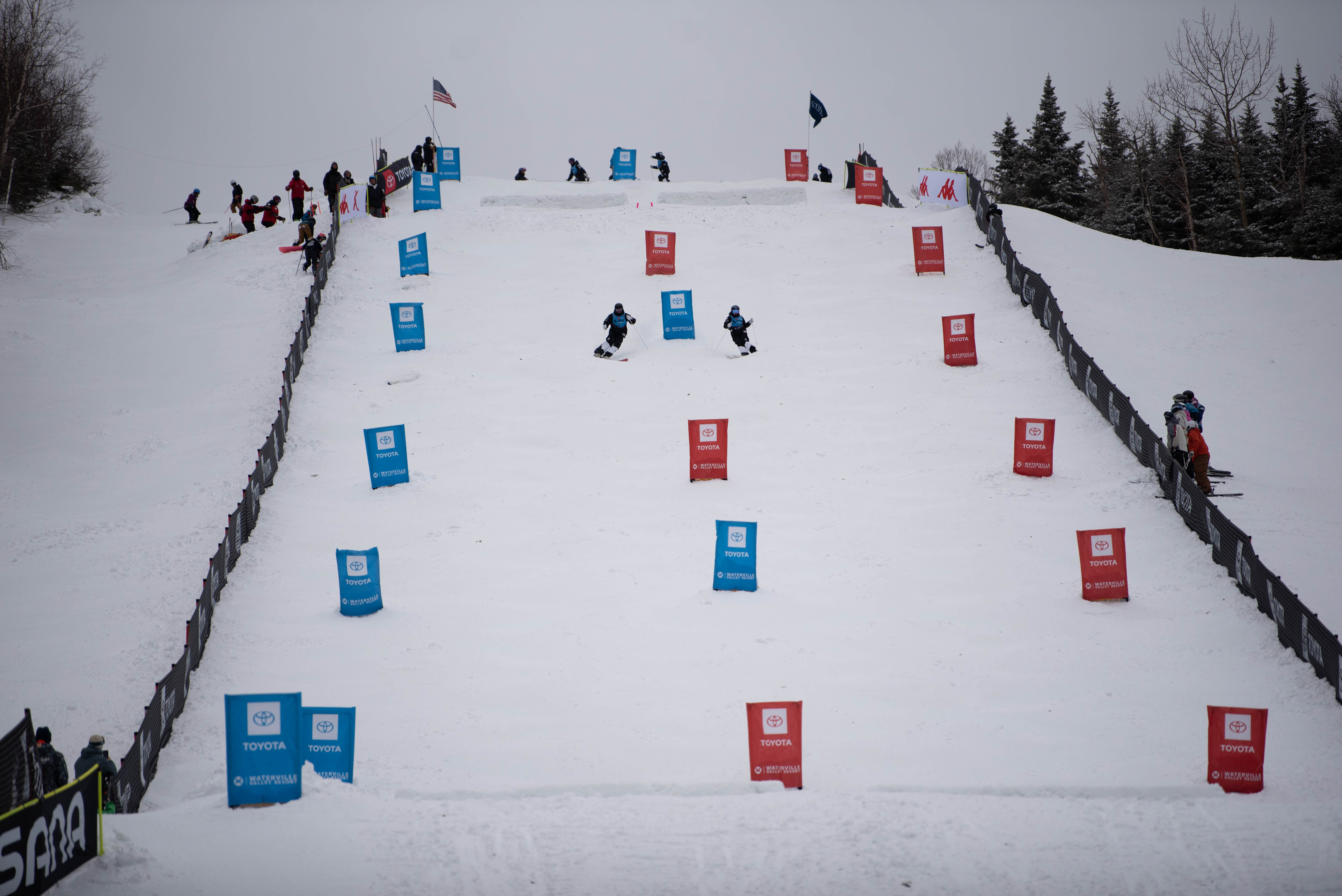Athletes skiing on a moguls course at Waterville