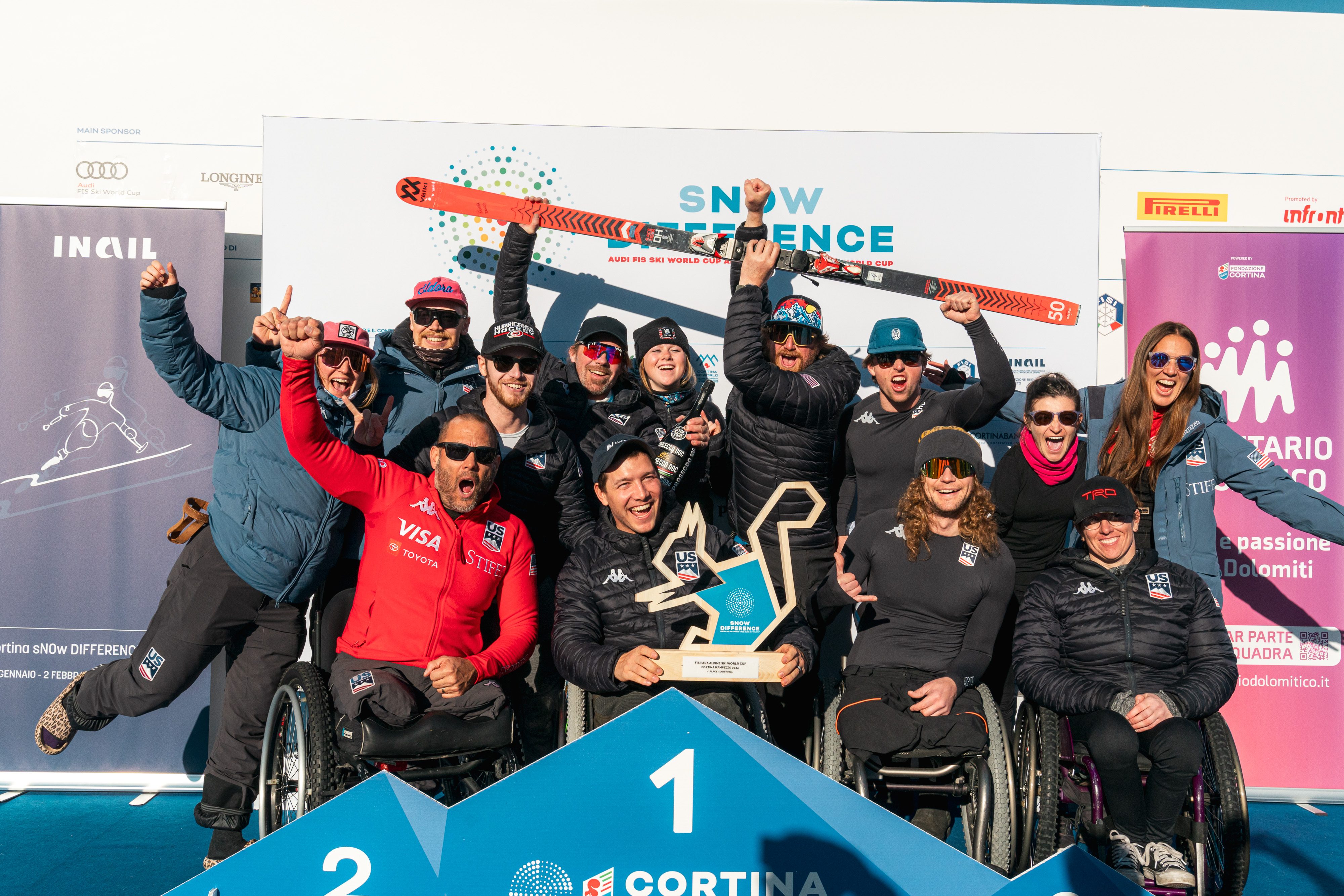 A group photo of the team on the podium in Cortina following Andrew Kurka's downhill win