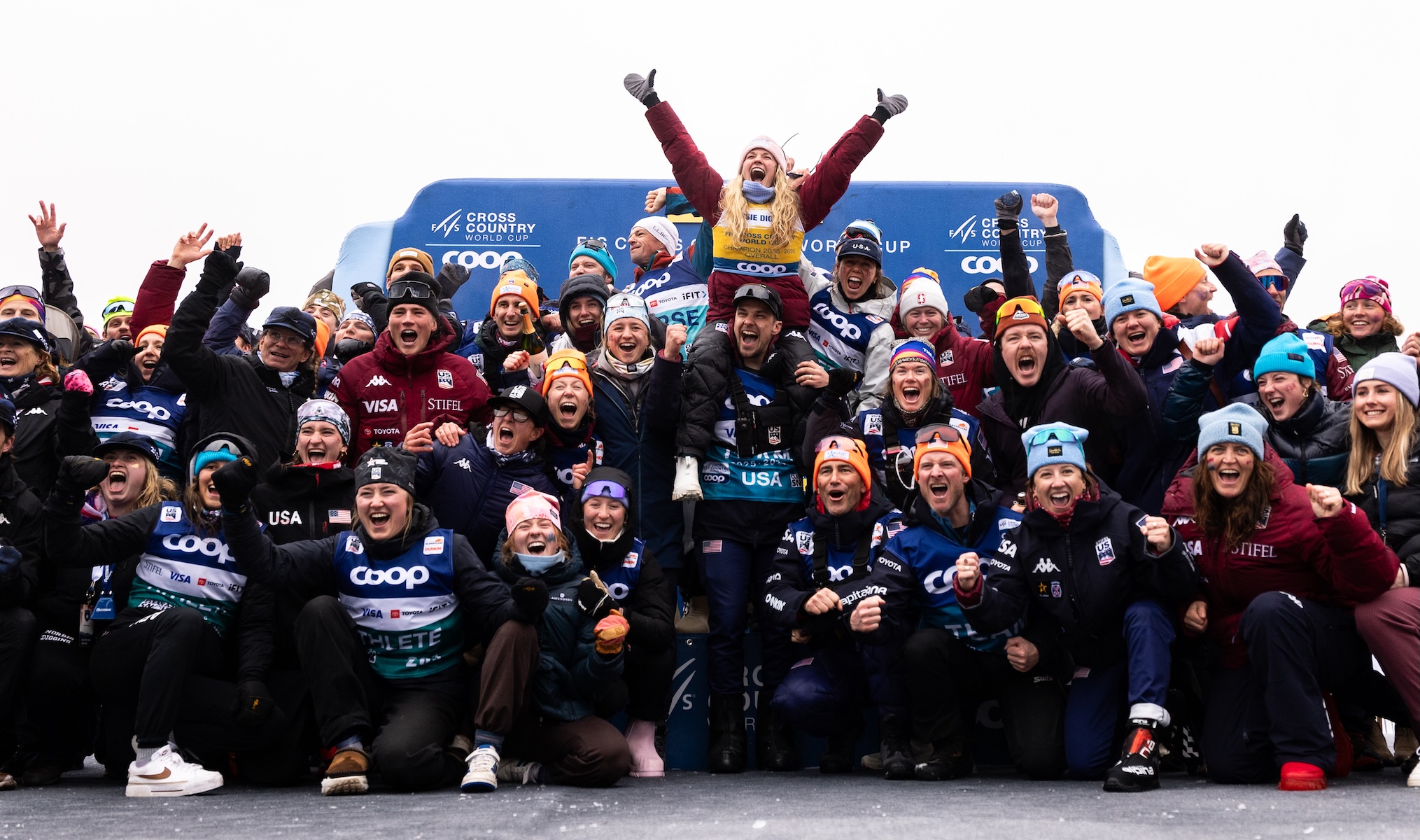 cross country ski team celebrating together on the podium