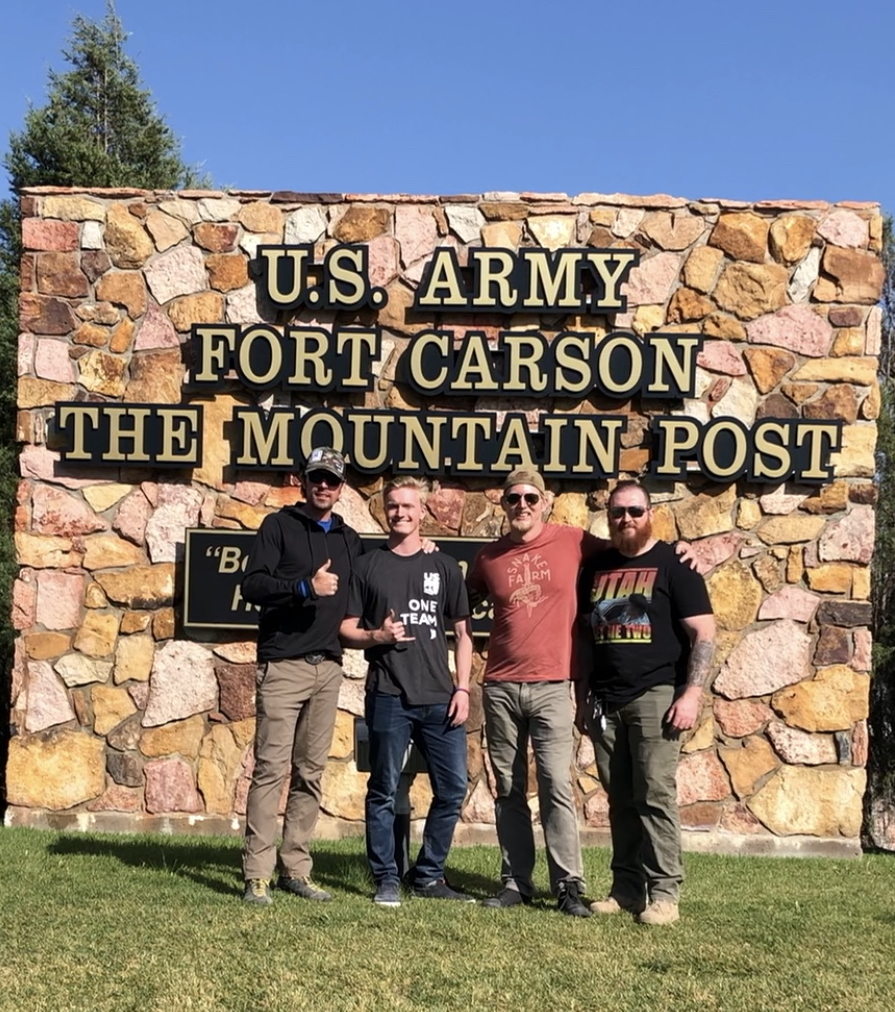 Jason Wolle in front of Fort Carson sign.