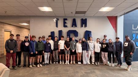 Project Gold participants gather for a photo in front of the Team USA sign at the USOPTC