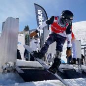 U.S. Para Snowboard athlete pushes out of the gate during a snowboardcross race